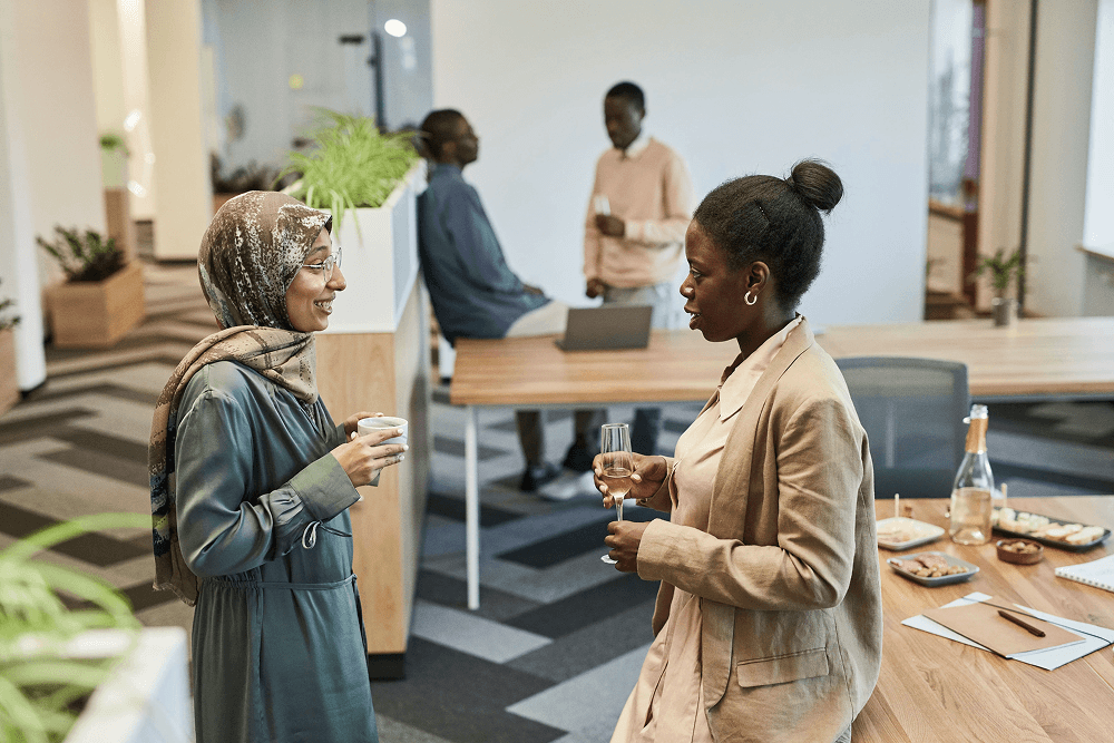Two professionals speaking at an event reception