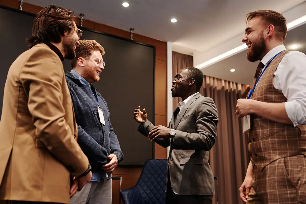 A group of attendees in conversation at a conference